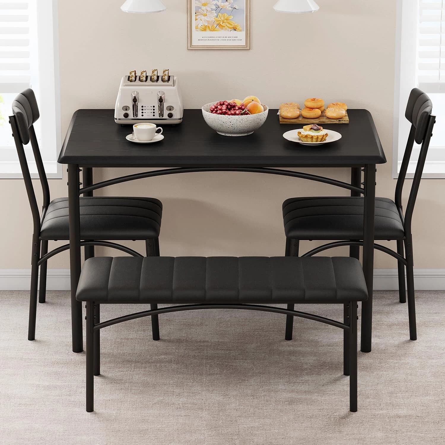 Black dining table with two upholstered chairs and a matching bench